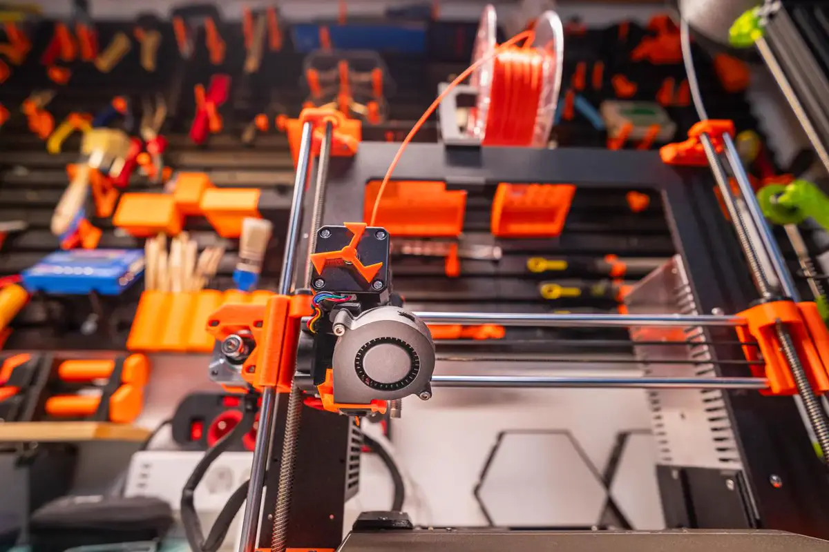 Une imprimante 3D et ses bobines de filament dans un atelier